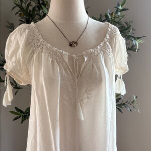 Joie cream short sleeve blouse with beautiful embroidered detail and tassels.